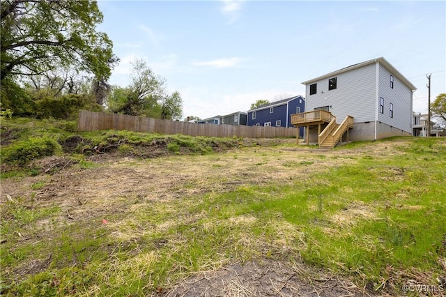 view of yard with central AC unit, stairs, fence, and a deck