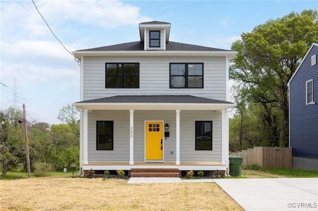 traditional style home featuring a porch and fence