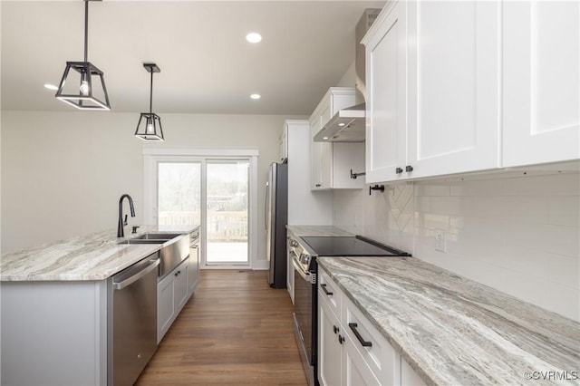 kitchen featuring backsplash, appliances with stainless steel finishes, white cabinetry, and a kitchen island with sink