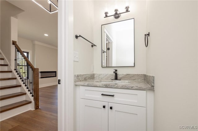 bathroom featuring wood finished floors, recessed lighting, and vanity