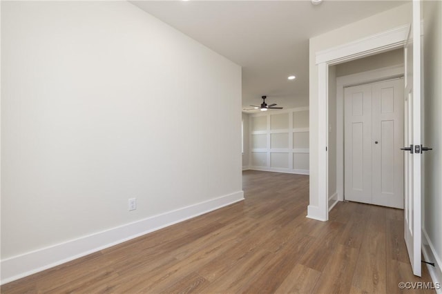 spare room featuring ceiling fan, baseboards, wood finished floors, and recessed lighting