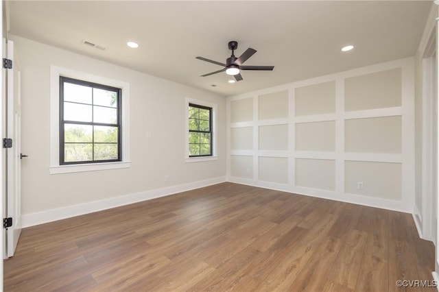 spare room featuring wood finished floors, visible vents, and recessed lighting