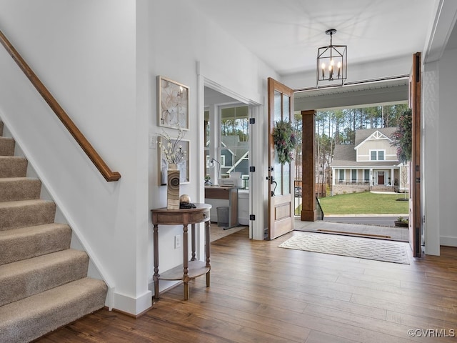 18525 Cove Creek Dr, Moseley, VA 23120 - entryway with dark wood finished floors, a chandelier, baseboards, and stairs