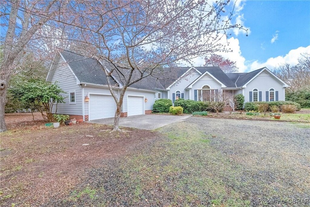 ranch-style home with an attached garage and concrete driveway