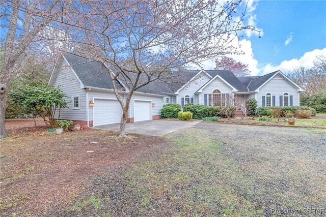 ranch-style home with an attached garage and concrete driveway