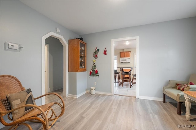 3057 Maury St, Richmond, VA 23224 - sitting room featuring light wood-style flooring, arched walkways, and baseboards