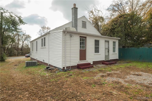 3057 Maury St, Richmond, VA 23224 - rear view of house with a chimney, crawl space, central AC unit, entry steps, and fence