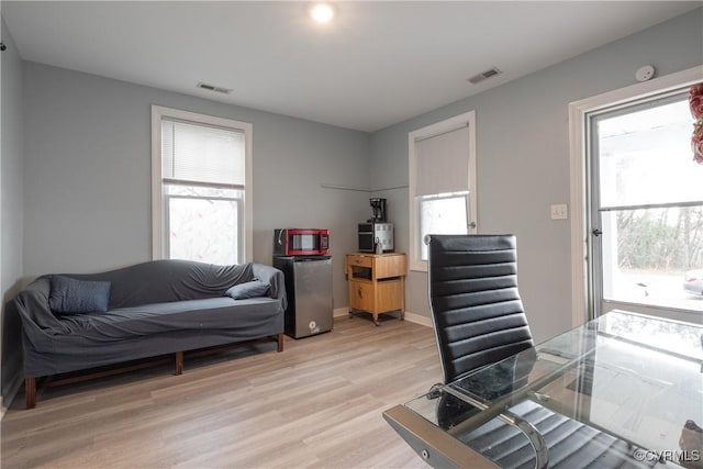 3057 Maury St, Richmond, VA 23224 - office area with light wood-style floors, visible vents, and a wealth of natural light