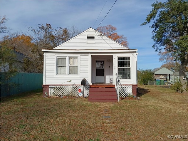 3057 Maury St, Richmond, VA 23224 - view of front of home featuring a front lawn, fence, and covered porch