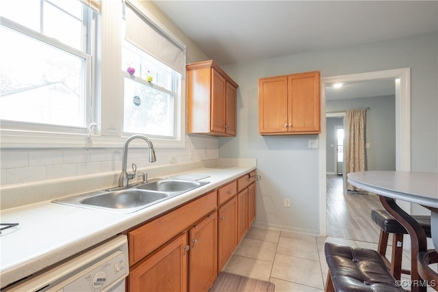 3057 Maury St, Richmond, VA 23224 - kitchen with light countertops, dishwasher, a sink, and light tile patterned floors