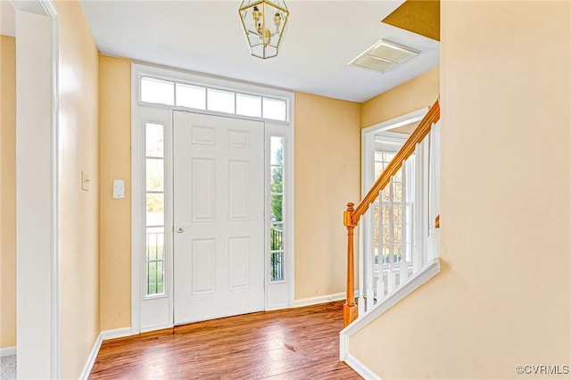 15116 Alderwood Turn, Chester, VA 23831 - foyer entrance featuring a wealth of natural light, visible vents, stairway, and wood finished floors