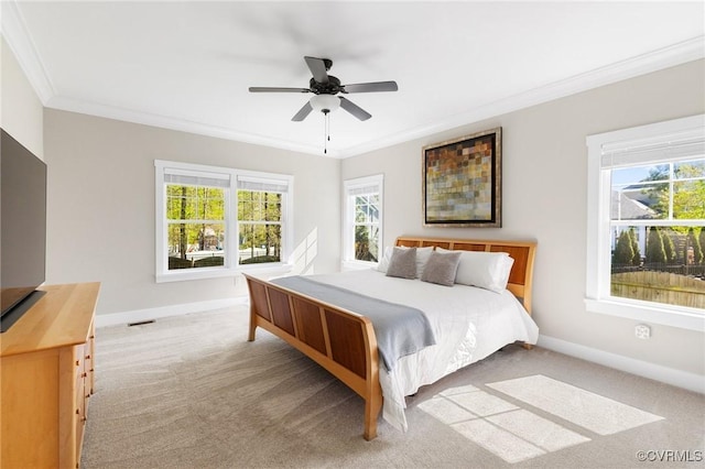 bedroom featuring ceiling fan, light carpet, baseboards, and ornamental molding