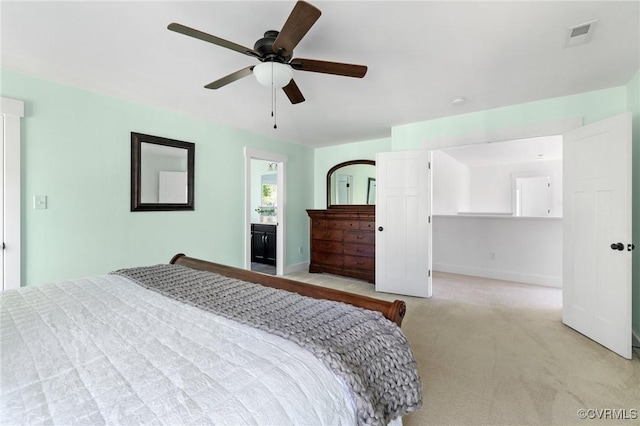 bedroom with light colored carpet, ceiling fan, baseboards, and visible vents
