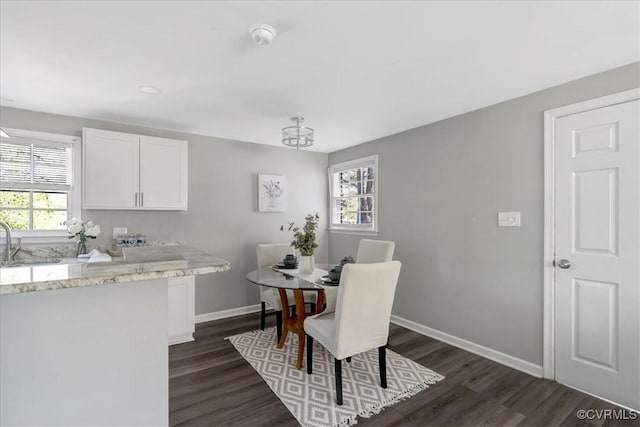 dining room with dark wood-style floors and baseboards