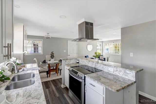 kitchen featuring a wealth of natural light, a sink, range hood, white cabinetry, and stainless steel electric stove