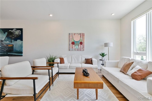living room featuring recessed lighting, wood finished floors, and a wealth of natural light