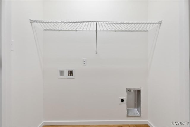 clothes washing area with electric dryer hookup, wood finished floors, hookup for a washing machine, and laundry area
