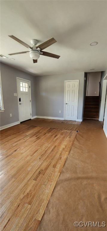 410 N Daisy Ave, Henrico, VA 23075 - unfurnished living room featuring baseboards, ceiling fan, and stairs