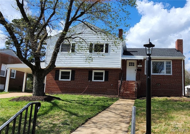 410 N Daisy Ave, Henrico, VA 23075 - tri-level home with a front lawn, a chimney, and brick siding