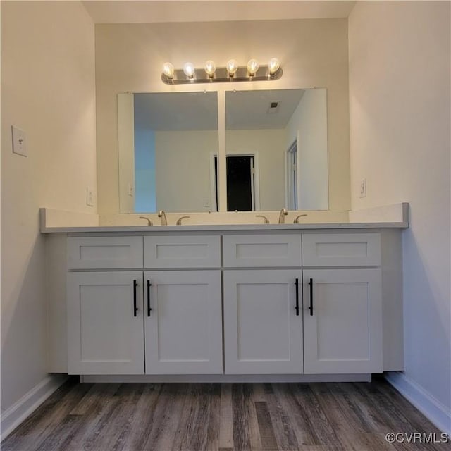 19164 Woodsons Mill Rd, Beaverdam, VA 23015 - bathroom featuring baseboards, wood finished floors, and double vanity