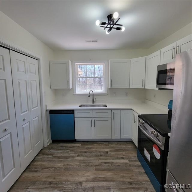 19164 Woodsons Mill Rd, Beaverdam, VA 23015 - kitchen featuring white cabinetry, light countertops, dark wood-style flooring, stainless steel appliances, and a sink