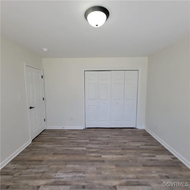 19164 Woodsons Mill Rd, Beaverdam, VA 23015 - unfurnished bedroom with baseboards, a closet, and wood finished floors