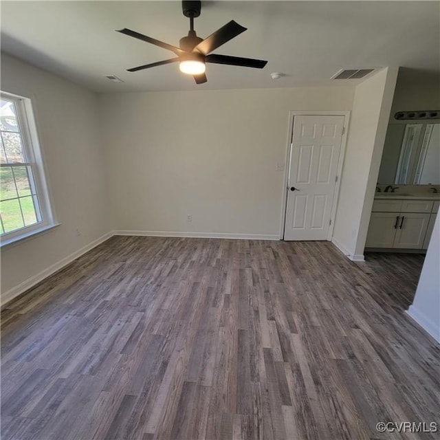 19164 Woodsons Mill Rd, Beaverdam, VA 23015 - unfurnished bedroom with baseboards, visible vents, dark wood-type flooring, and a sink