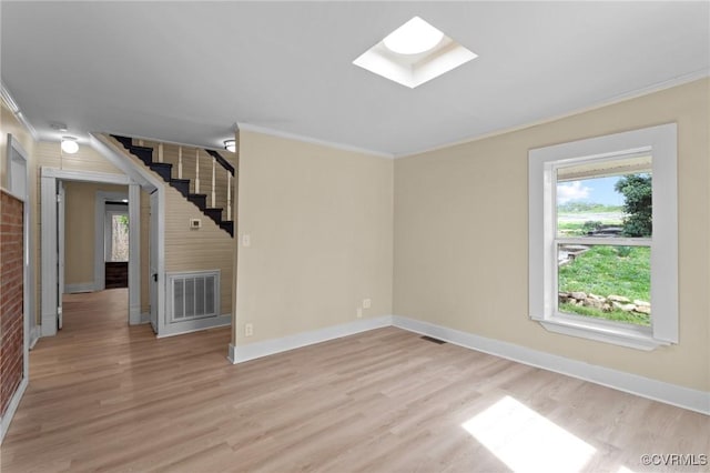 1413 First Rock Rd, Prospect, VA 23960 - unfurnished living room featuring visible vents, a skylight, ornamental molding, stairs, and light wood-style flooring