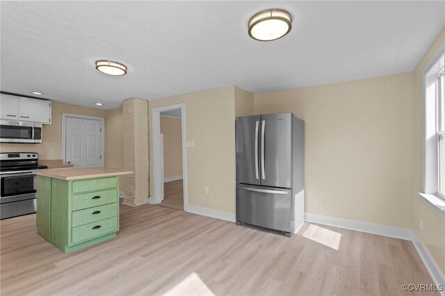1413 First Rock Rd, Prospect, VA 23960 - kitchen with appliances with stainless steel finishes, light countertops, baseboards, light wood-type flooring, and green cabinets