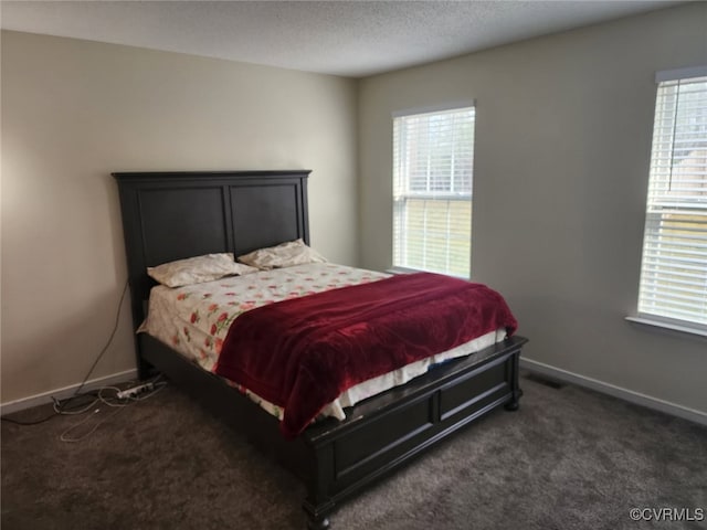 carpeted bedroom with baseboards and visible vents