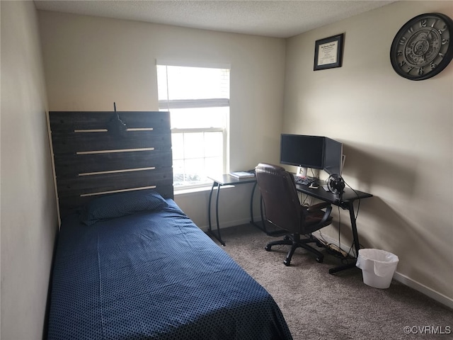 bedroom featuring baseboards, carpet floors, and a textured ceiling