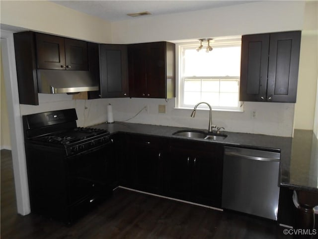 kitchen featuring stainless steel dishwasher, black range with gas stovetop, a sink, under cabinet range hood, and visible vents