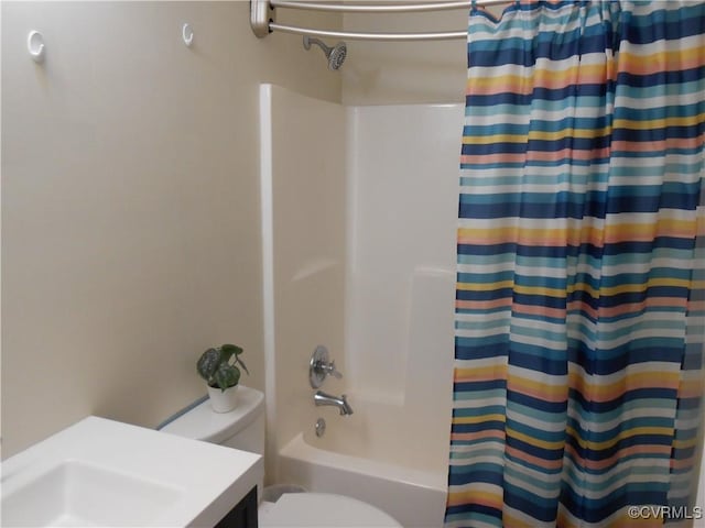 bathroom featuring shower / bath combo with shower curtain and toilet