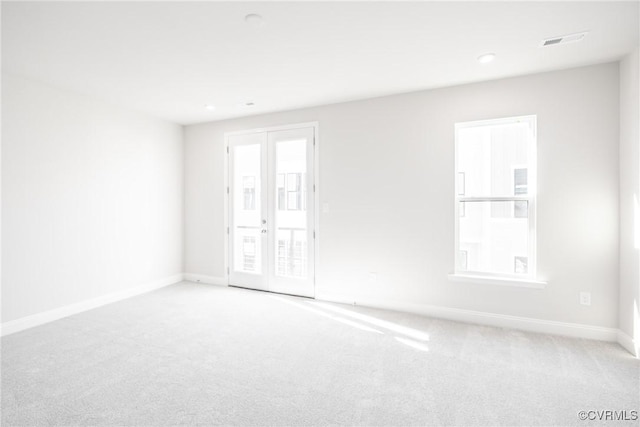 empty room featuring carpet flooring, baseboards, visible vents, and recessed lighting