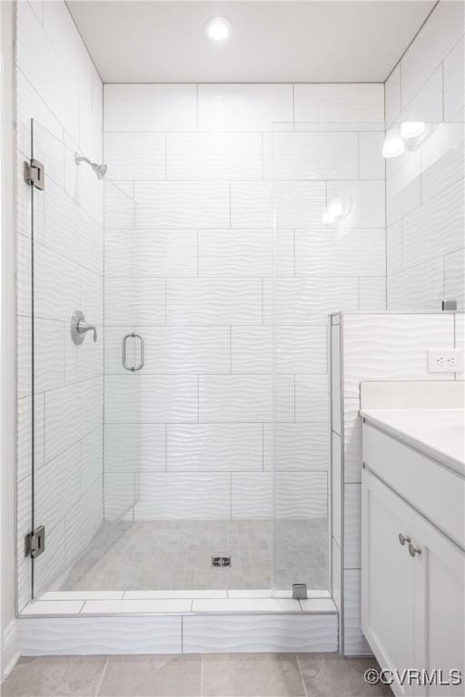 full bathroom featuring a shower stall, tile patterned flooring, and vanity