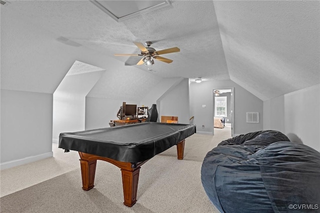 playroom with a textured ceiling, vaulted ceiling, light carpet, and baseboards