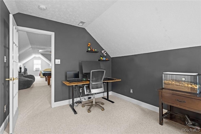 office area featuring baseboards, visible vents, a textured ceiling, and lofted ceiling
