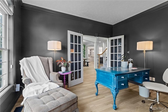office space featuring wood finished floors, french doors, and crown molding