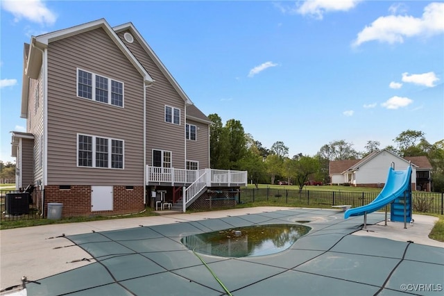 10011 Loblolly Ter, Amelia, VA 23002 - view of swimming pool featuring a water slide, a deck, fence, stairway, and central AC