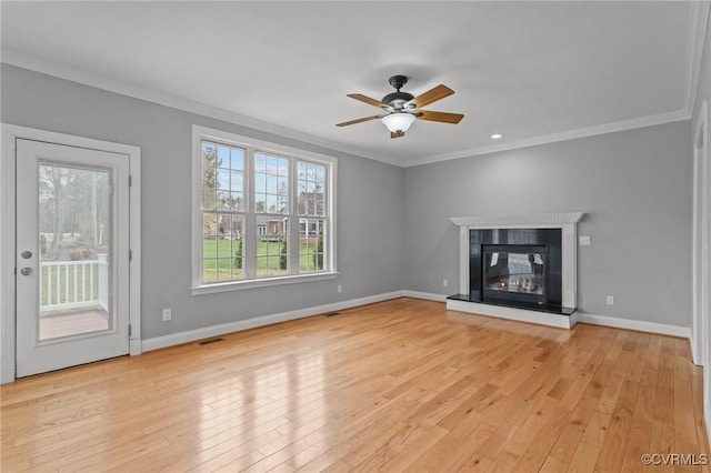 11421 Regal Ter, Providence Forge, VA 23140 - unfurnished living room with crown molding, light wood-type flooring, ceiling fan, baseboards, and a glass covered fireplace