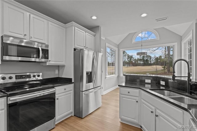 11421 Regal Ter, Providence Forge, VA 23140 - kitchen featuring stainless steel appliances, a sink, white cabinets, light wood-style floors, and lofted ceiling