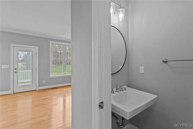 11421 Regal Ter, Providence Forge, VA 23140 - bathroom with wood finished floors, baseboards, ornamental molding, and a sink