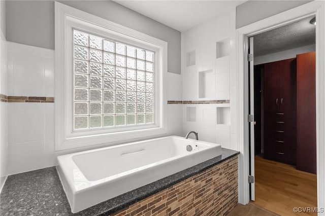 11421 Regal Ter, Providence Forge, VA 23140 - bathroom with healthy amount of natural light and a garden tub