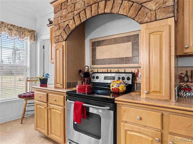 kitchen featuring light brown cabinets, crown molding, and stainless steel electric range