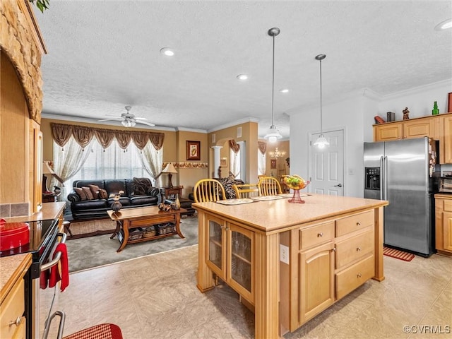 kitchen with light countertops, a ceiling fan, appliances with stainless steel finishes, glass insert cabinets, and ornamental molding