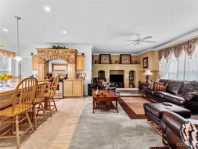 living room featuring a textured ceiling, ornamental molding, recessed lighting, and a ceiling fan