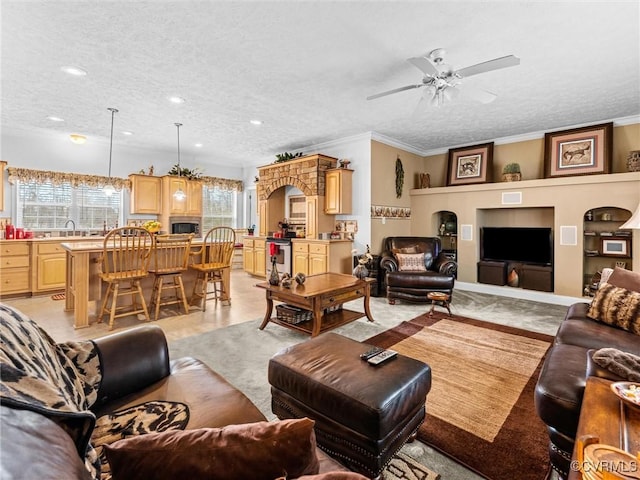 living room featuring a textured ceiling, ceiling fan, recessed lighting, and crown molding