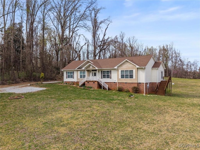 ranch-style house with crawl space, roof with shingles, and a front lawn