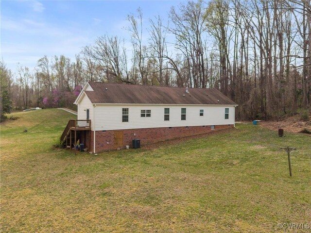 view of property exterior with central air condition unit, crawl space, stairway, and a yard