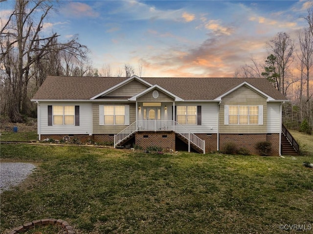 view of front facade featuring crawl space, a front yard, stairway, and roof with shingles